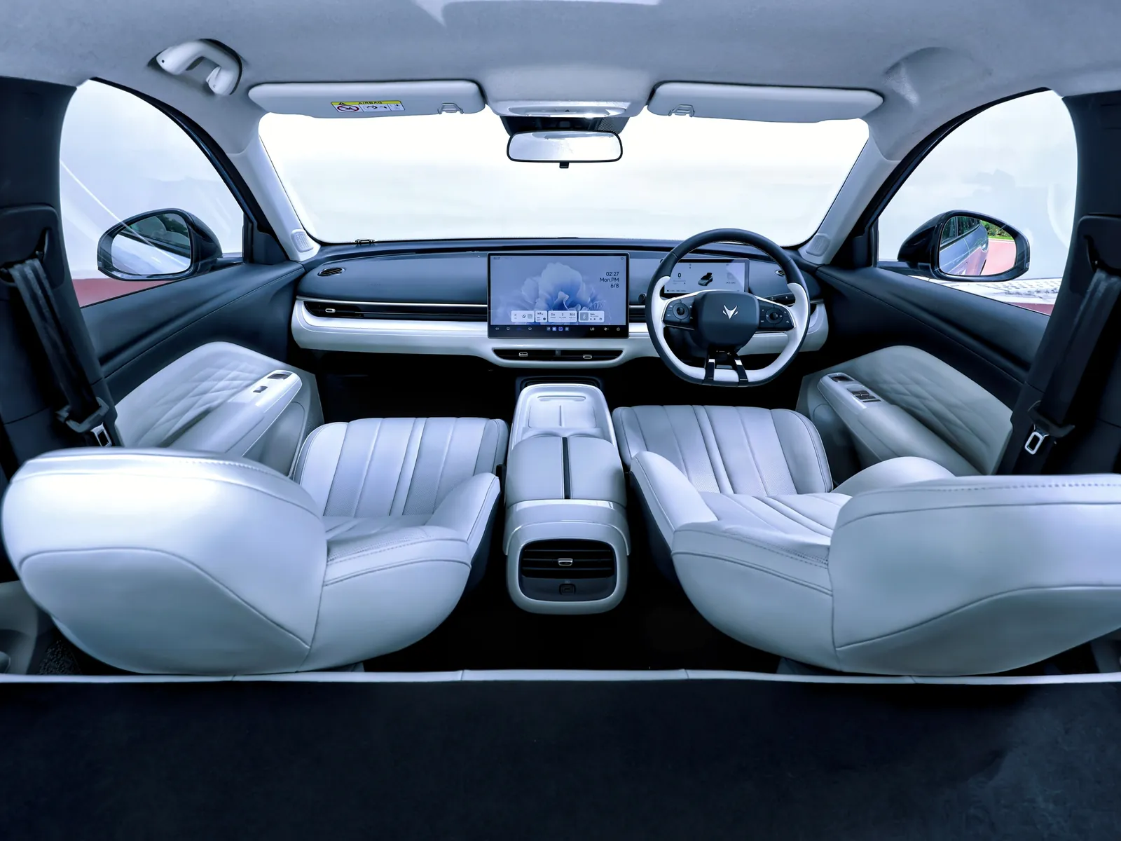 Right-hand-drive ARCFOX T1 cabin seen from the boot, with light grey front seats