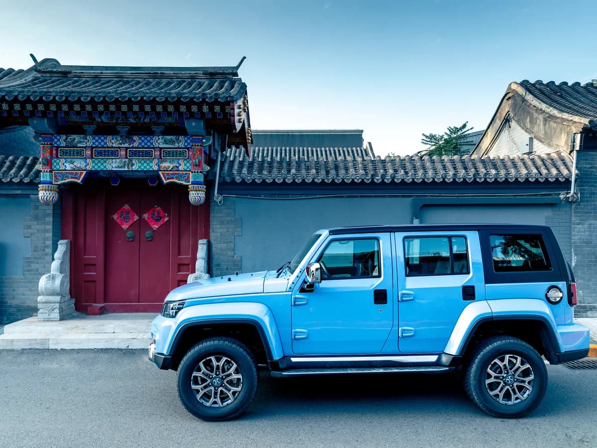 Sky Blue BAIC BJ40 Plus outside a courtyard gate in Beijing