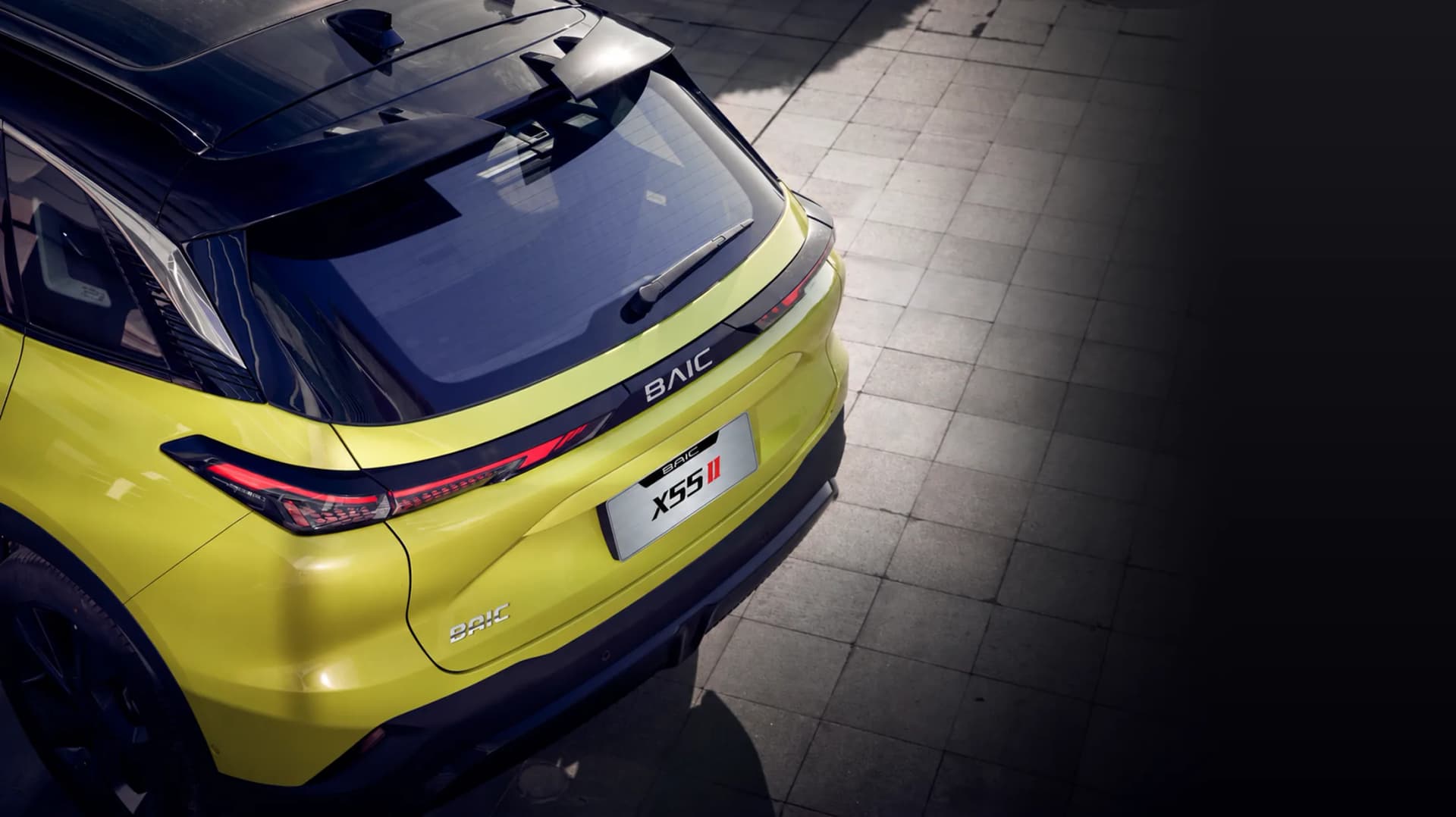 Lemon Yellow BAIC X55 II from above, BAIC badge on the tailgate